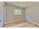 This bedroom features wood-look floors and a window that provides natural light at 2610 Crestview Rd, Wimauma, FL 33598