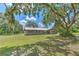 Spacious single-story home with mature oak tree coverage and a large front yard at 2610 Crestview Rd, Wimauma, FL 33598