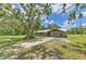 Charming single-story home with mature tree coverage and a long driveway at 2610 Crestview Rd, Wimauma, FL 33598