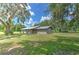 Side view of single-story home with mature trees at 2610 Crestview Rd, Wimauma, FL 33598