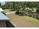 Expansive front yard with mature trees providing ample shade and natural beauty at 2610 Crestview Rd, Wimauma, FL 33598