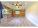 Functional laundry room featuring wood paneling and ample lighting for a practical space at 2610 Crestview Rd, Wimauma, FL 33598