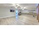 Spacious living room features wood-look flooring, a stylish stone accent wall, and modern ceiling fans at 2610 Crestview Rd, Wimauma, FL 33598
