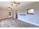 Inviting living area with light wood-look floors, showcasing access to the kitchen at 2610 Crestview Rd, Wimauma, FL 33598