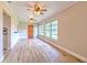 Open living space with wood-look floors, featuring a modern front door and ample natural light at 2610 Crestview Rd, Wimauma, FL 33598