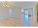 Spacious and airy living area showcases wood-look floors with easy access to the kitchen and other rooms at 2610 Crestview Rd, Wimauma, FL 33598