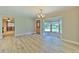 Open-concept living area features a bay window, wood floors, and a view into additional rooms at 2610 Crestview Rd, Wimauma, FL 33598