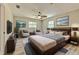 Nicely decorated main bedroom boasts a ceiling fan and plenty of natural light at 2610 Crestview Rd, Wimauma, FL 33598