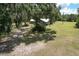 Expansive property with lush greenery, mature trees draped in Spanish moss, and a quaint single story home at 2610 Crestview Rd, Wimauma, FL 33598