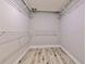 Walk-in closet with wire shelving and wood-look floors at 2610 Crestview Rd, Wimauma, FL 33598