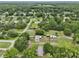 This aerial view showcases the neighborhood, highlighting tree coverage and providing a sense of community at 26223 Chianina Dr, Wesley Chapel, FL 33544