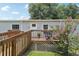 Close-up of the front deck with seating and a wooden ramp at 26223 Chianina Dr, Wesley Chapel, FL 33544