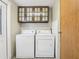 Bright laundry area with overhead cabinets and easy access to outdoor entry at 26223 Chianina Dr, Wesley Chapel, FL 33544