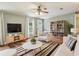Inviting living room featuring hardwood floors, neutral walls, modern furnishings, and an abundance of natural light at 26223 Chianina Dr, Wesley Chapel, FL 33544