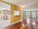 Open-concept living room flows into kitchen with wood paneling detail at 26223 Chianina Dr, Wesley Chapel, FL 33544