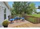 Cozy rear deck with seating and lush landscaping in the backyard at 26223 Chianina Dr, Wesley Chapel, FL 33544