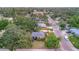 Birds-eye view of a home featuring a well-manicured lawn, mature trees, and a tranquil neighborhood setting at 301 Kingston S St, St Petersburg, FL 33711