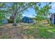 Enjoy the outdoors in this backyard featuring mature trees, a hammock, and a cozy sitting area at 301 Kingston S St, St Petersburg, FL 33711
