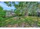 Large backyard featuring mature trees, a hammock, and plenty of green space at 301 Kingston S St, St Petersburg, FL 33711