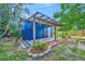 Charming outdoor area with a cozy patio and a wooden pergola perfect for enjoying the outdoors at 301 Kingston S St, St Petersburg, FL 33711