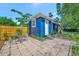 Cozy backyard featuring a tiled patio, privacy fence and beautiful landscaping at 301 Kingston S St, St Petersburg, FL 33711