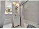 Bathroom featuring a vanity sink, toilet, tub with shower, and a window at 301 Kingston S St, St Petersburg, FL 33711