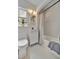 Bathroom featuring a vanity sink, toilet, tub with shower, and a window at 301 Kingston S St, St Petersburg, FL 33711