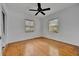 Bedroom featuring hardwood floors, ceiling fan, and natural light from two windows at 301 Kingston S St, St Petersburg, FL 33711