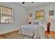Bright bedroom featuring hardwood floors, ceiling fan, and natural light from two windows at 301 Kingston S St, St Petersburg, FL 33711