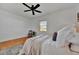 Bedroom featuring hardwood floors, ceiling fan, neutral rug, and natural light at 301 Kingston S St, St Petersburg, FL 33711