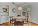 Cozy dining room with modern table and decorative light fixture by a bright window at 301 Kingston S St, St Petersburg, FL 33711
