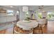 Charming dining area with a round table, wooden chairs, and open to a bright living space at 301 Kingston S St, St Petersburg, FL 33711