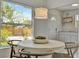 Dining area featuring a round table, stylish chairs and a bright window view at 301 Kingston S St, St Petersburg, FL 33711