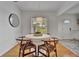 Clean dining area with round table, wooden chairs and a window that provides natural light at 301 Kingston S St, St Petersburg, FL 33711