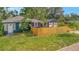 Charming blue home featuring a fenced yard and detached two-car garage at 301 Kingston S St, St Petersburg, FL 33711