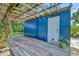 Outdoor patio area by the detached garage features a wooden pergola and privacy at 301 Kingston S St, St Petersburg, FL 33711