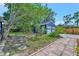 Detached garage nestled in a tranquil backyard with lush landscaping and a wooden patio at 301 Kingston S St, St Petersburg, FL 33711