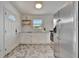 Charming kitchen boasting stainless steel appliances, white cabinets, and unique flooring at 301 Kingston S St, St Petersburg, FL 33711
