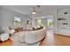Bright living room with hardwood floors, built-in shelving, and large windows at 301 Kingston S St, St Petersburg, FL 33711
