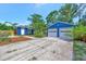 Charming home with a two car garage and ample parking space surrounded by mature landscaping at 301 Kingston S St, St Petersburg, FL 33711