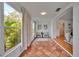 Bright sunroom leading into living area, featuring beautiful tile and arched doorway at 301 Kingston S St, St Petersburg, FL 33711