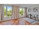 Bright sunroom featuring red-tiled floors, large windows and views of lush greenery at 301 Kingston S St, St Petersburg, FL 33711