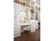Walk-in closet boasts custom shelving, a vanity area, modern lighting, and hardwood floors at 322 Capri Blvd, Treasure Island, FL 33706