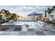 Backyard swimming pool and jacuzzi with lounge chairs and umbrella overlooking the bay at 322 Capri Blvd, Treasure Island, FL 33706