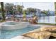 Backyard swimming pool with jacuzzi, Adirondack chairs and fire pit overlooking the bay at 322 Capri Blvd, Treasure Island, FL 33706