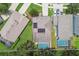 A high aerial view shows a home with a pool, solar panels, and well-maintained landscaping in a suburban neighborhood at 3530 Brook Crossing Dr, Brandon, FL 33511