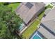 Aerial view of houses with screened-in pools, solar panels, and manicured lawns at 3530 Brook Crossing Dr, Brandon, FL 33511
