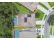 Aerial view of homes with screened pools, solar panels, and manicured lawns, showcasing a well-maintained community at 3530 Brook Crossing Dr, Brandon, FL 33511