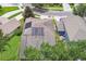 The aerial view highlights a home with solar panels on the roof and a meticulously kept lawn at 3530 Brook Crossing Dr, Brandon, FL 33511