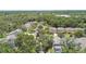 An aerial view shows homes in a wooded community offering mature landscaping, green spaces, and a tranquil setting at 3530 Brook Crossing Dr, Brandon, FL 33511